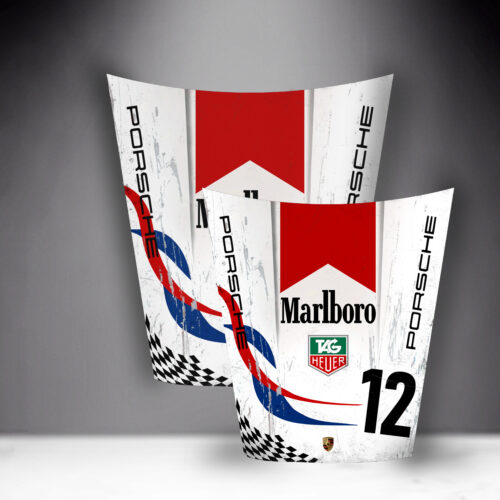 Two Porsche car hoods with Marlboro, TAG Heuer, and number 12 logos, featuring a red and blue design with a checkered pattern.