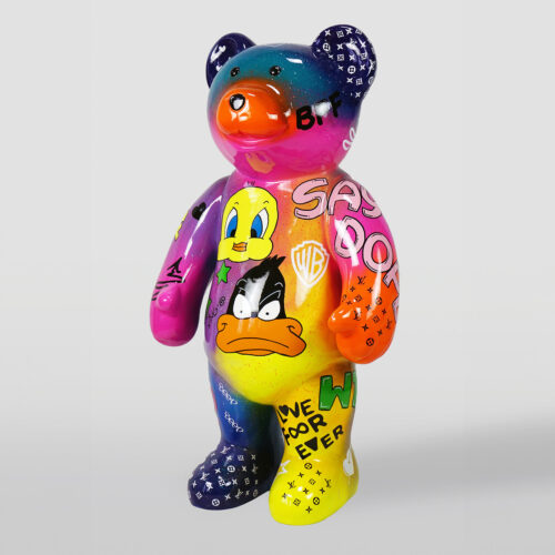 Colorful bear sculpture adorned with pop art-style paintings of cartoon characters, brand logos, and various graffiti-like texts.