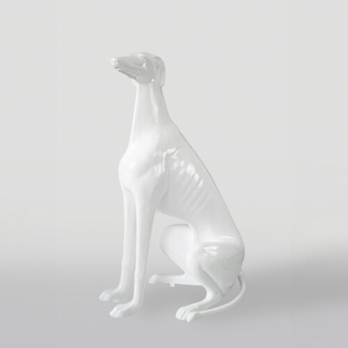 White glossy statue of a sitting dog with a sleek and elegant body shape.