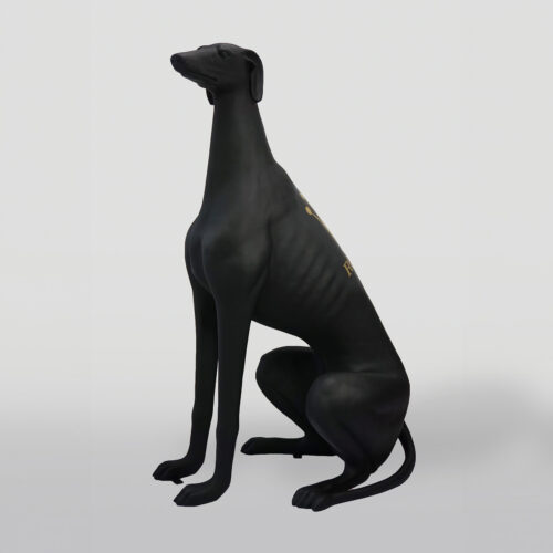 Black greyhound statue sitting upright.