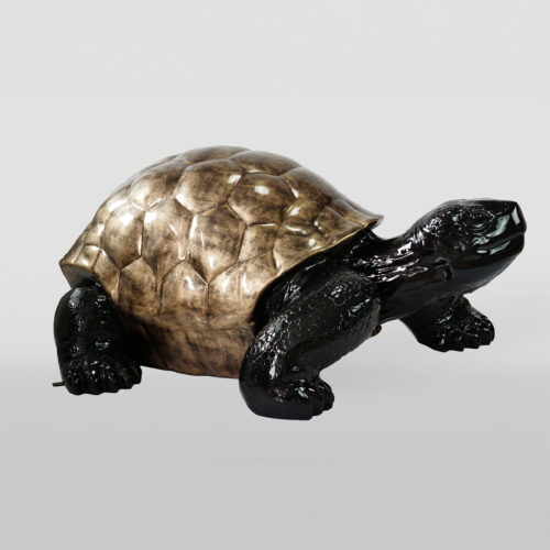 Sculpture of a turtle with a bronze-colored shell and black body.