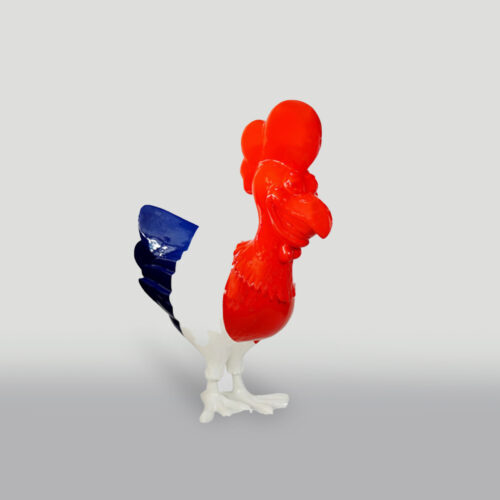 Statue of a rooster with a blue tail, red body, and white legs.