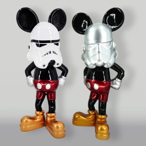 Two statues of Mickey Mouse in Stormtrooper helmets with arms akimbo, one helmet white and the other silver.