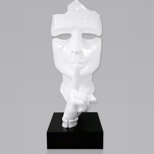 White mask sculpture with finger to lips in a
