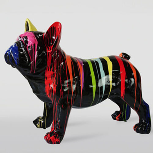 A black bulldog statue with multicolored paint drips in various colors such as red, yellow, green, blue, and pink.