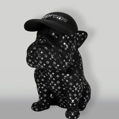 Statue of a black bulldog wearing a black cap with