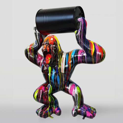 Colorful gorilla sculpture holding a black barrel, with multi-colored paint drips on its surface.
