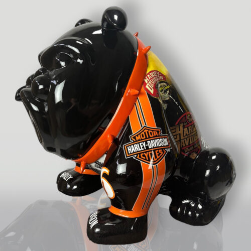 Black bulldog figurine with Harley-Davidson-themed decorations and an orange studded collar.