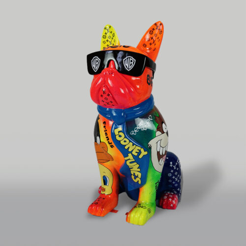 Colorful French Bulldog statue with Looney Tunes cartoon characters painted on it and wearing black Warner Bros sunglasses.