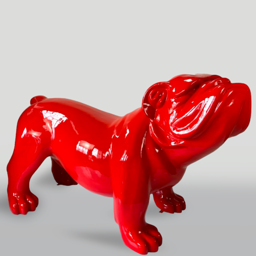 Red glossy bulldog statue on a plain background.