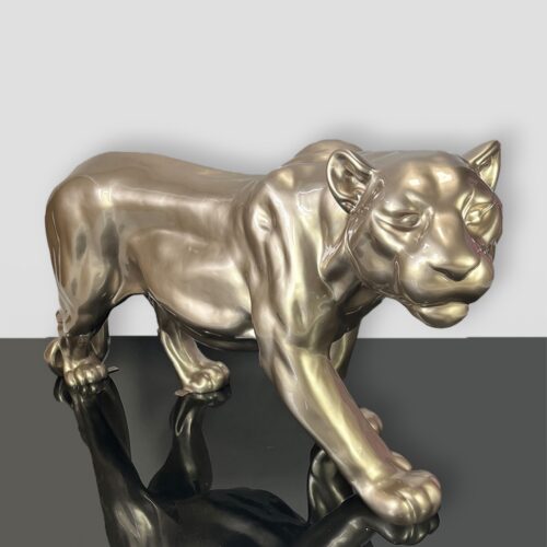 Bronze statue of a prowling panther on a glossy black surface.