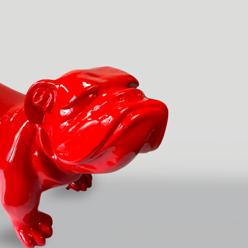 Red ceramic bulldog sculpture with a glossy finish against a plain background.
