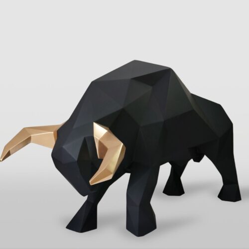 Sculpture of a geometric black bull with golden horns.