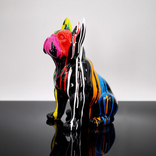 Colorful French Bulldog figurine with multi-colored paint drips on a glossy black surface.