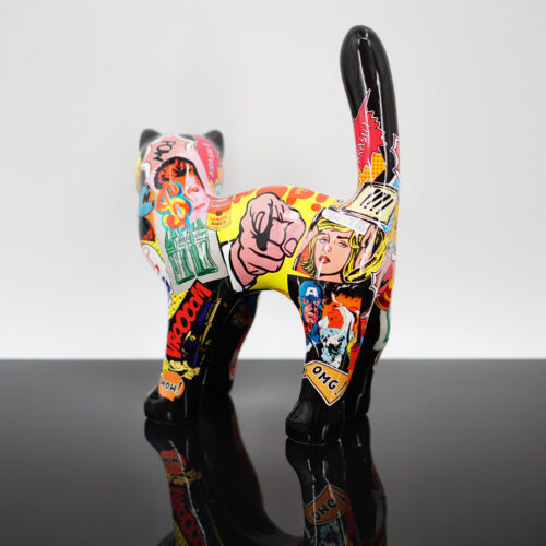 Pop art cat sculpture adorned with colorful comic-style graphics, standing on a glossy black surface.
