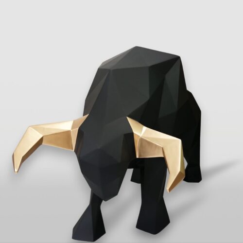 Geometric black bull sculpture with gold-colored horns.