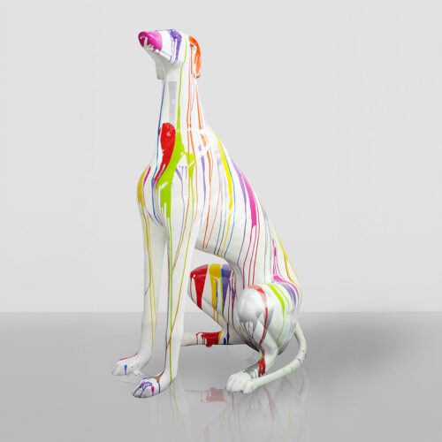 White dog sculpture with colorful paint drips, set against a plain background.