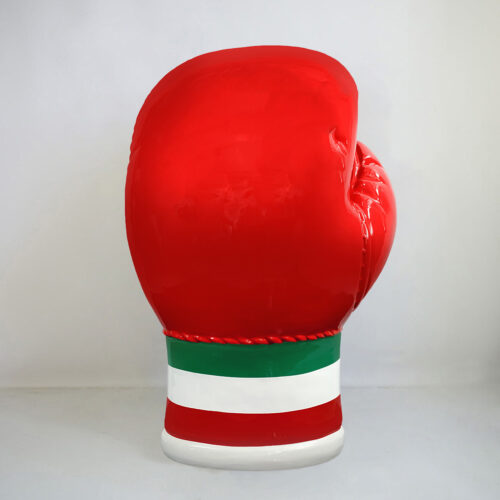 Large red boxing glove sculpture with green and white stripes at the base.