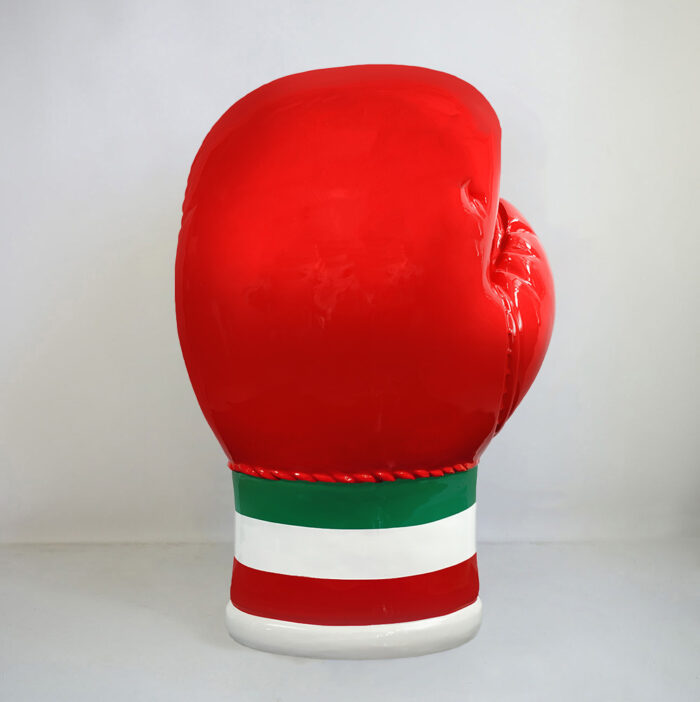 Large red boxing glove sculpture with green and white stripes at the base.