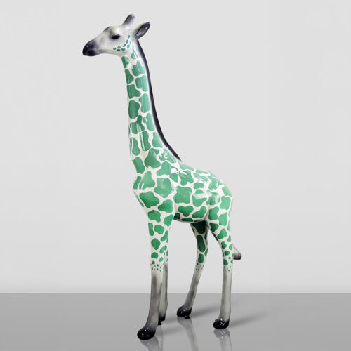 Figurine of a giraffe with a green and white spotted pattern on its body, black gradient legs, and a black-to-white gradient neck and head.
