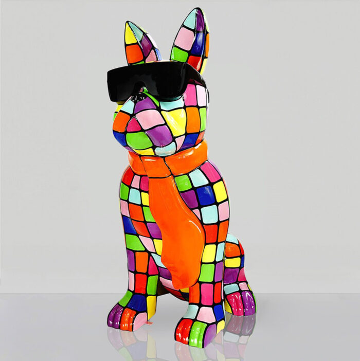 Colorful mosaic sculpture of a dog wearing sunglasses and an orange scarf.