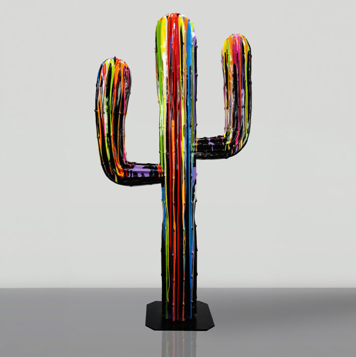 Colorful cactus-shaped sculpture with rainbow streaks against a plain background.