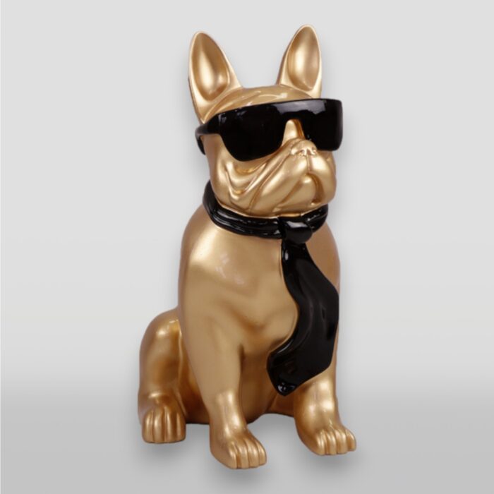 Gold-colored French Bulldog statue wearing black sunglasses and a black scarf.