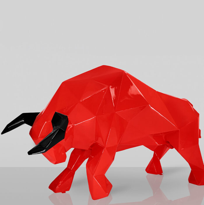 Geometric red bull sculpture with black horns on a gray background.