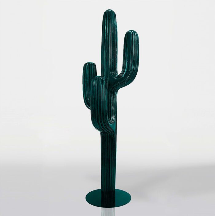 Green cactus-shaped sculpture with a base.