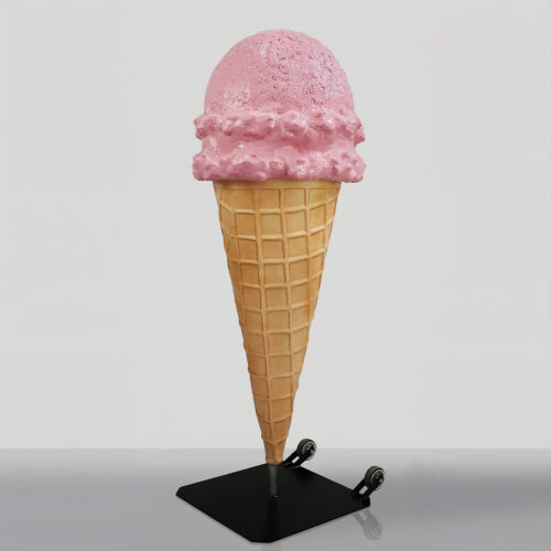 A large ice cream cone sculpture with a pink scoop on top, mounted on a black metal stand with wheels.