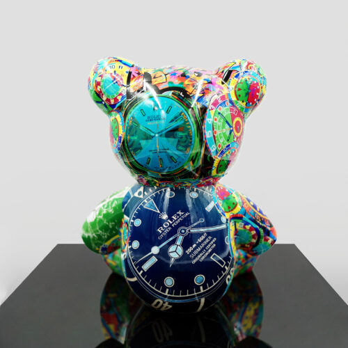 Colorful bear sculpture with various Rolex watch designs incorporated into its surface, placed on a black reflective platform.