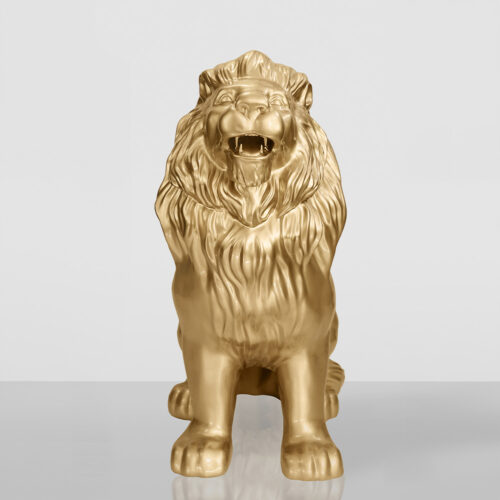 Gold lion statue on a reflective surface.