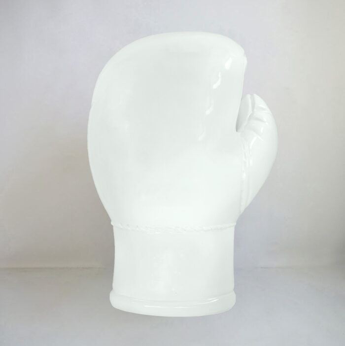 White porcelain sculpture of a boxing glove.