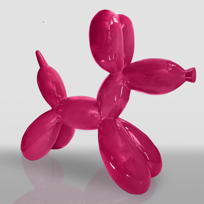 Pink balloon dog sculpture on a white background.