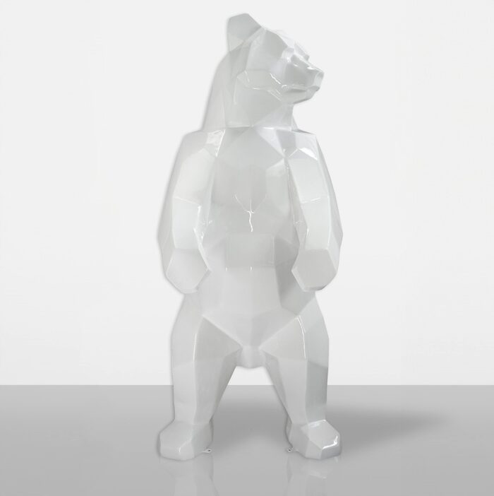 White geometric bear sculpture standing on a smooth surface.