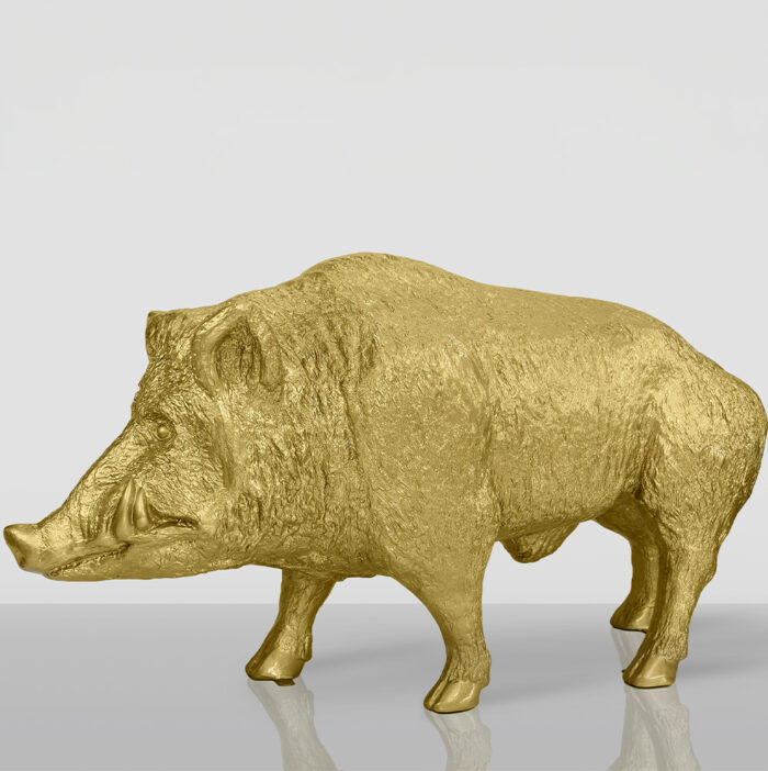 Golden wild boar sculpture with detailed texture on a light gray background.