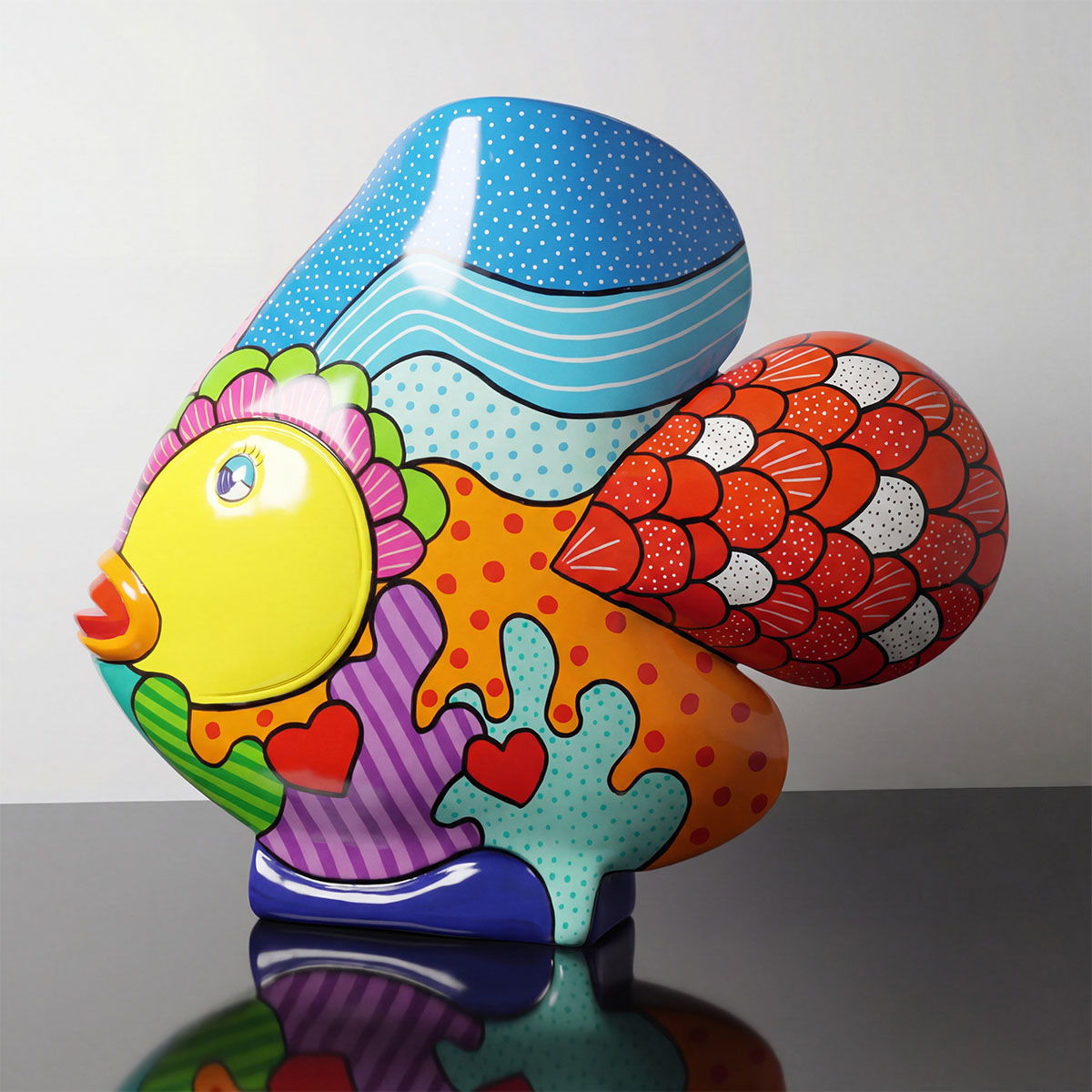 figure fish sculpture in fiberglass with bright pop-art patterns blue, yellow, red decorative display for malls or events