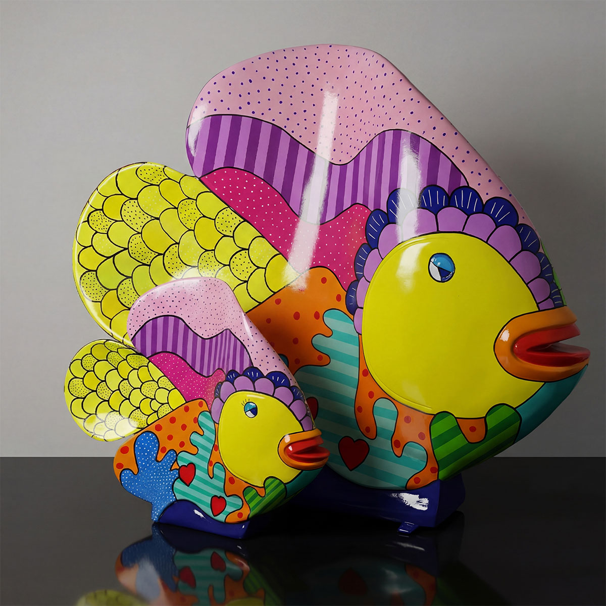 sculpture fish figure in glossy fiberglass with bright pop-art colors and patterns, decorative display for mall or event