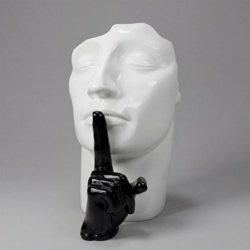 sculpture head figure in glossy white fiberglass with a black glossy hand finger to lips, modern decorative display for interiors