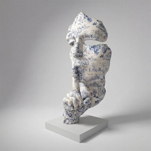 figure human face sculpture in blue toile pattern on white fiberglass, artistic decorative piece for interiors or events