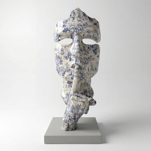 sculpture mask figure in blue-and-white toile pattern on fiberglass, stylized face with finger-to-lips pose for decor or display