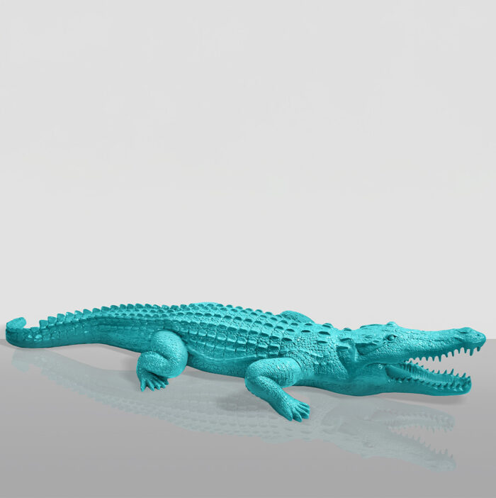 A turquoise alligator sculpture with its mouth open, displayed against a light grey background.