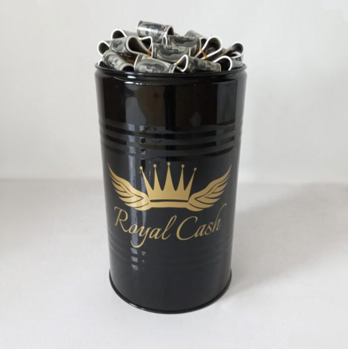 Black cylindrical container labeled "Royal Cash" with golden crown and wings emblem, filled with rolled up currency notes.