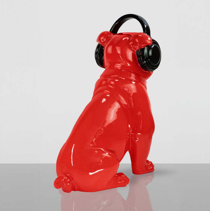 Red bulldog sculpture wearing black headphones.