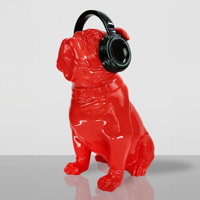 Red bulldog statue wearing black headphones.