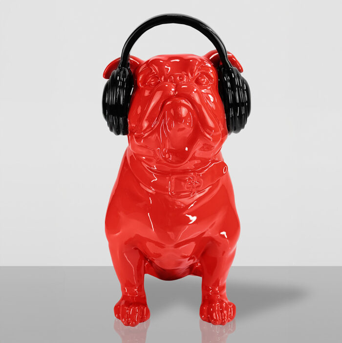 Red bulldog figurine wearing black headphones.