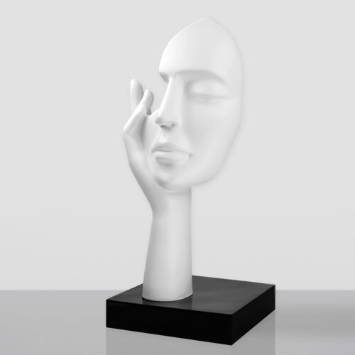 White sculpture of a serene human face resting gently on a raised hand, mounted on a black rectangular base against a plain light gray background