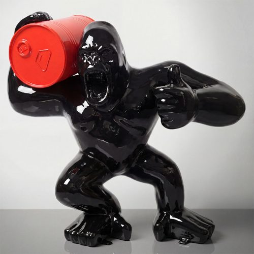 figure gorilla sculpture in glossy black fiberglass holding a red barrel, pop art style for advertising or mall decor