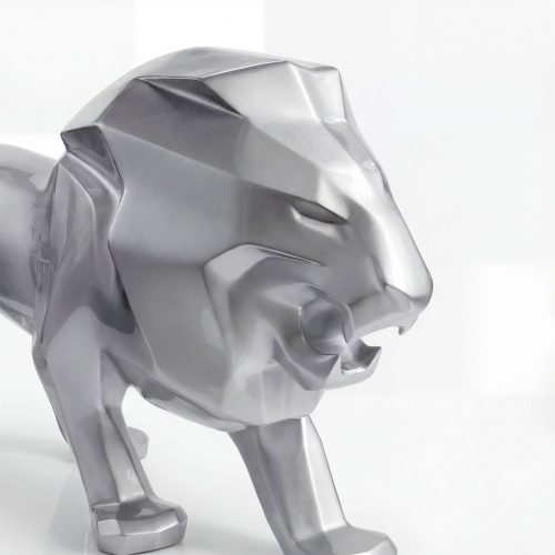 sculpture lion figure in glossy silver laminate with geometric facets, modern decorative piece for interior or mall advertising