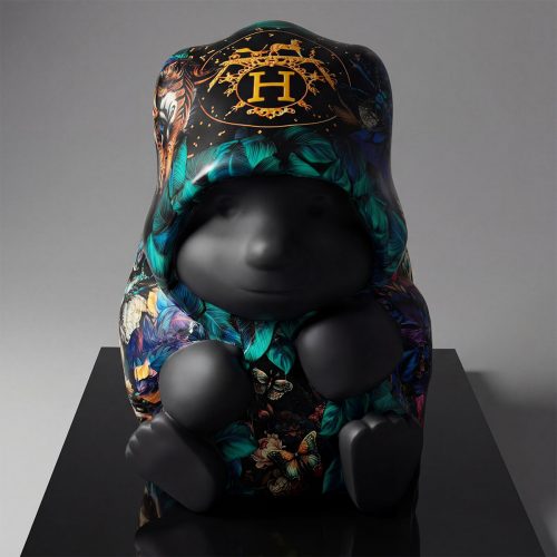 figure baby sculpture in black fiberglass with colorful floral and butterfly hood and gold